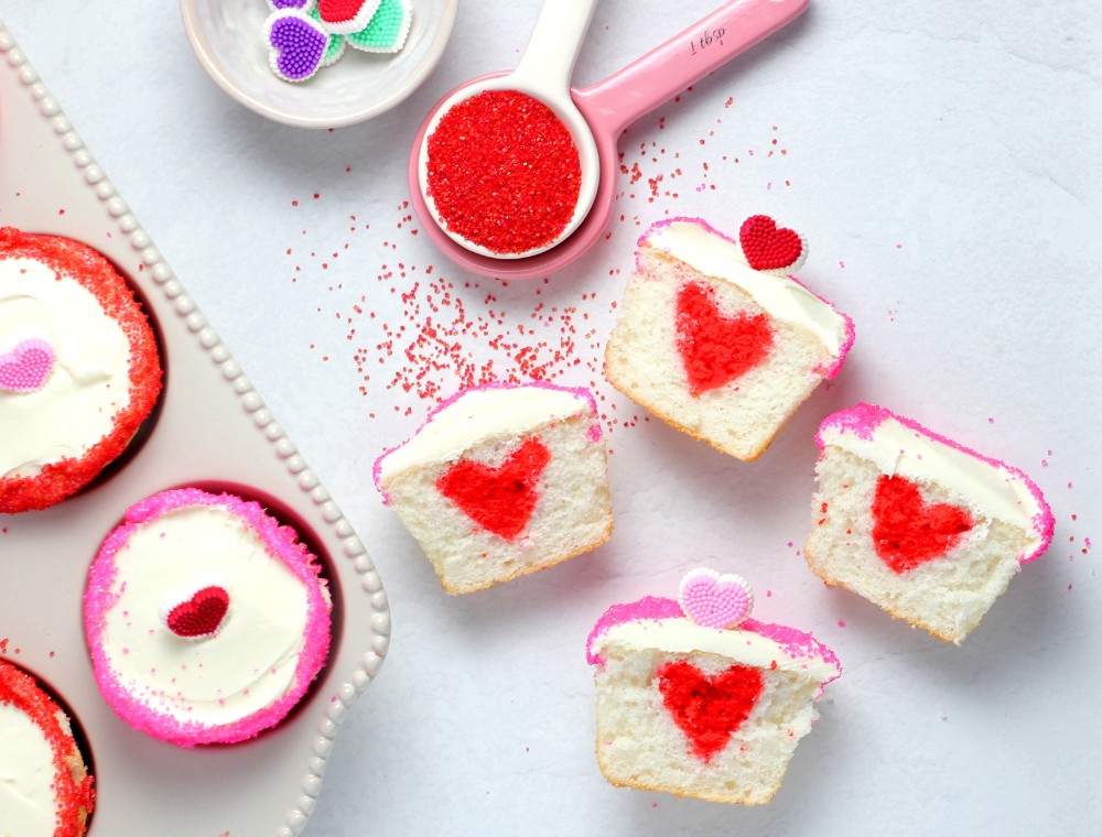 valentine's day cupcakes with red hearts in the center