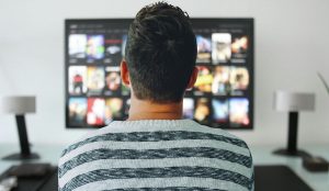 person looking at a tv screen deciding what to watch next
